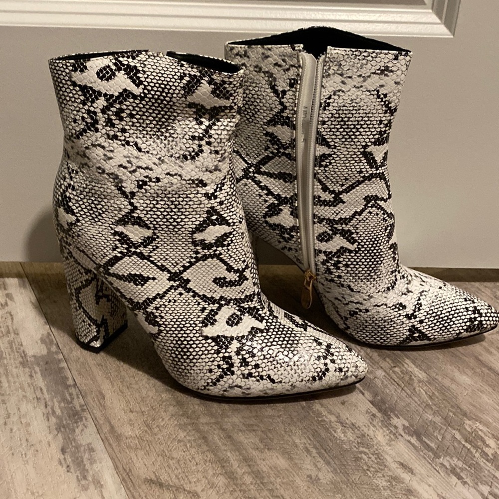 Black and white snake skim boots.